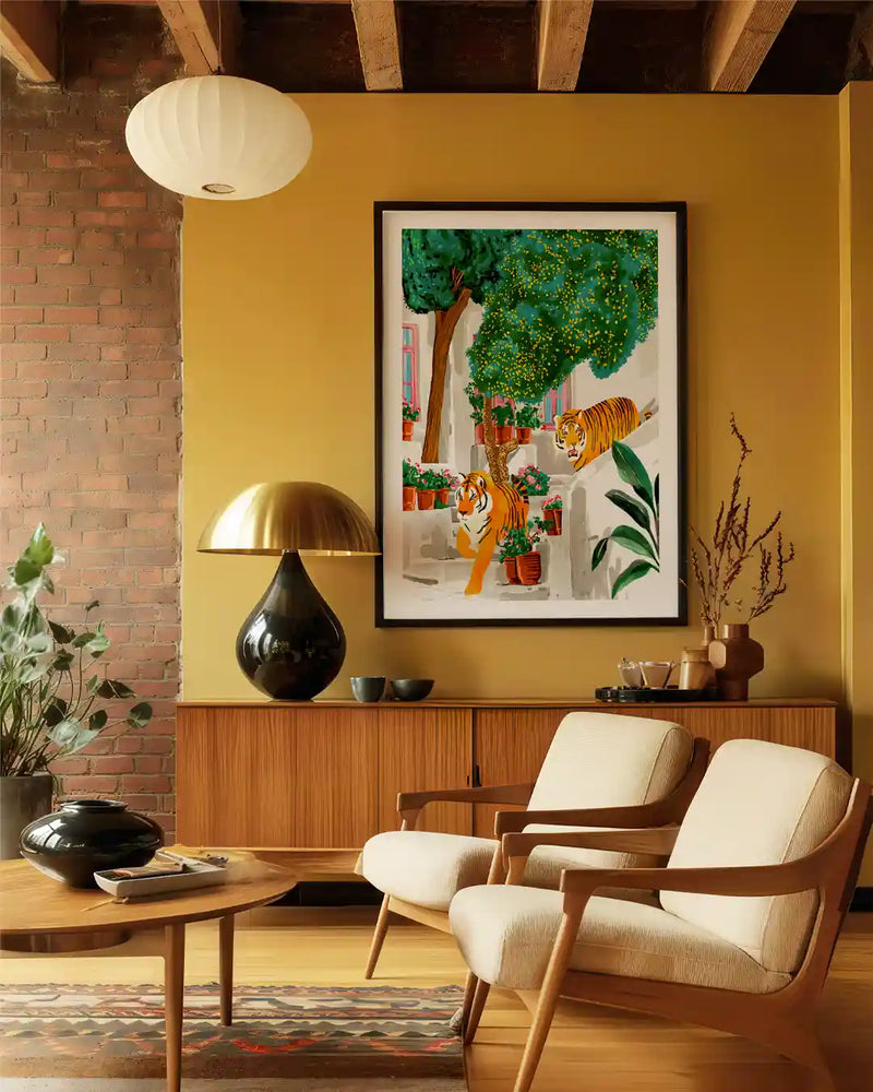 A stylish mid-century modern living room featuring a framed tiger wall art print as the focal point.The artwork shows two tigers in a lush courtyard scene, adding a bold and artistic touch to the interior.Warm mustard walls, wooden furniture, and neutral armchairs create a cozy, contemporary aesthetic.Decor accents like sculptural table lamps, indoor plants, and textured rugs enhance the modern home decor.