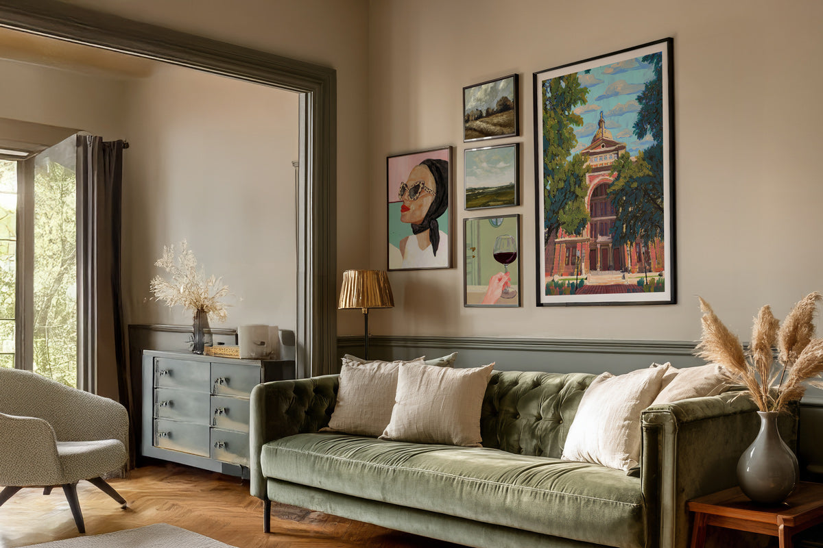 Living room with a green sofa, armchair, and wall art